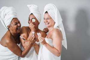 Multigenerational women having fun using skin care products - Skin care therapy